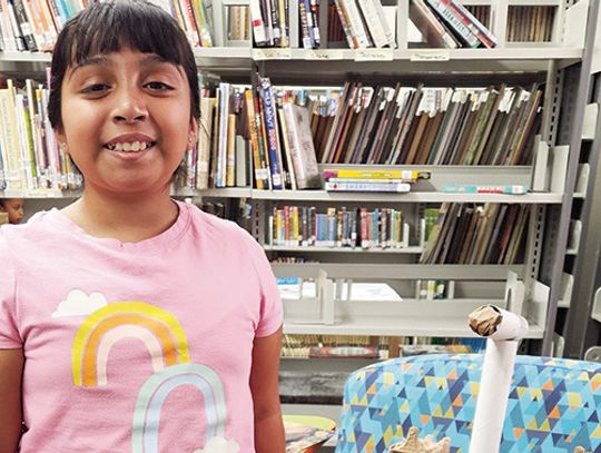 A student displays her self-made creation at Eastland Library’s summer program