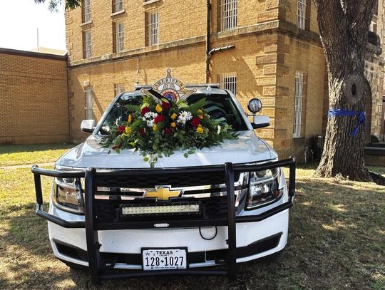 Patrol Vehicle with Flowers set up at Sheriff’s Office