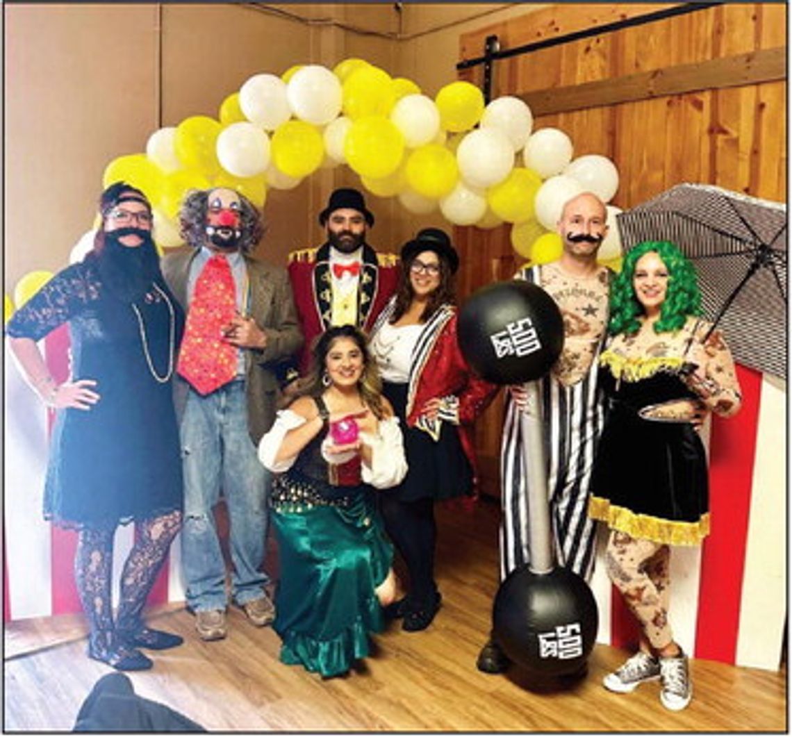 Participants costumed to a Circus Theme enjoy Kathleen Jackson Boots & Bags Event