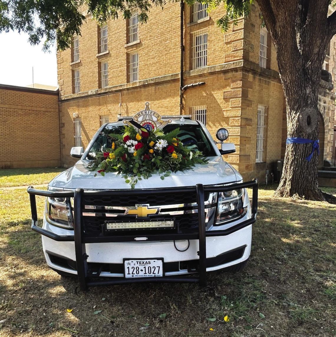 Patrol Vehicle with Flowers set up at Sheriff’s Office